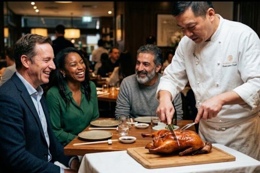 A chef carving a roasted turkey at a dining table with guests. 1