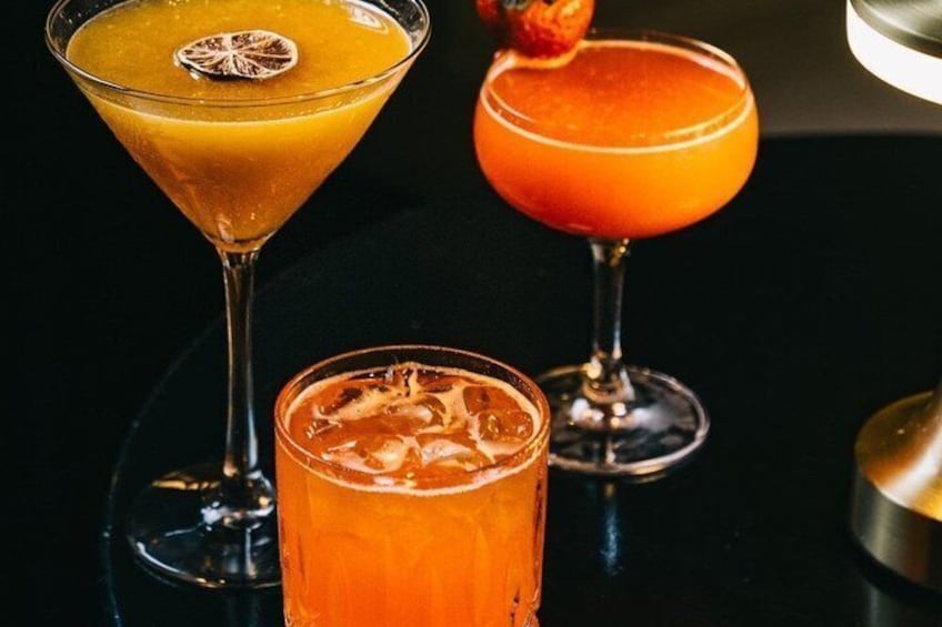 Three cocktails in martini glasses with ice cubes. 5
