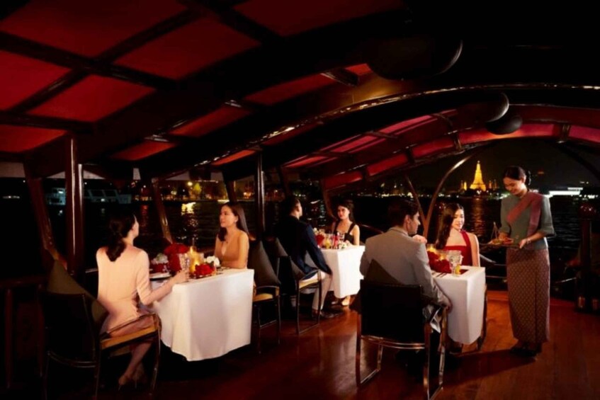 An indoor dining area with tables, chairs, and a waiter. 5
