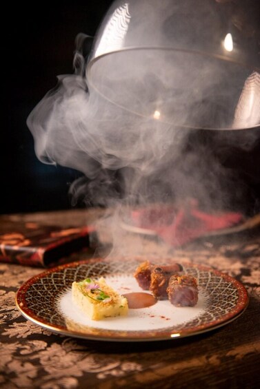 A plate with food items and a steaming pot emitting steam. 3