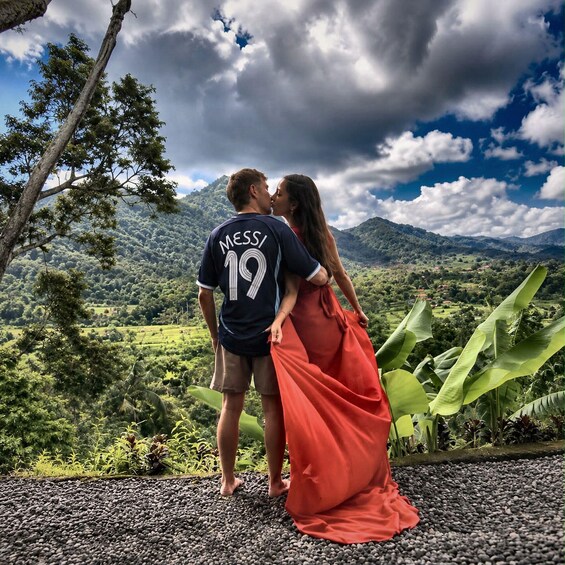 A couple embracing with a mountainous landscape in the background. 4