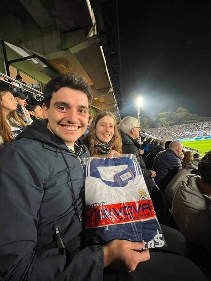 A person holding a bag with a sports team logo. 5