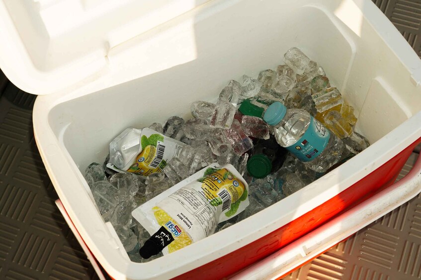A cooler filled with ice and various beverages. 5