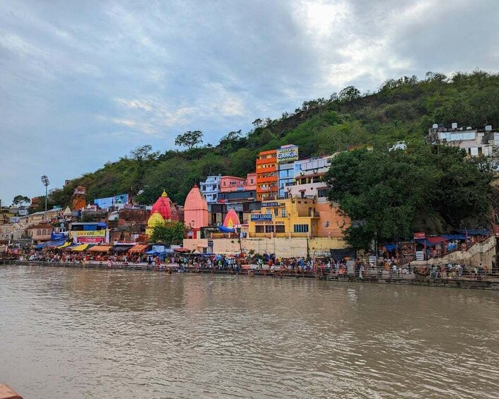 A riverside town with colorful buildings and a crowd by the water. 3
