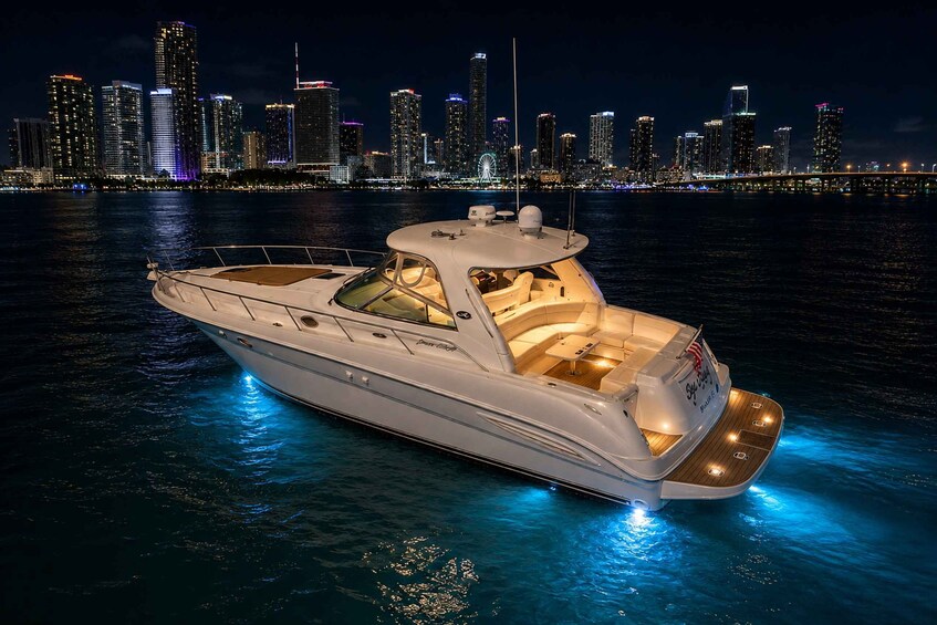 A luxury yacht on calm waters with a city skyline in the background. 4
