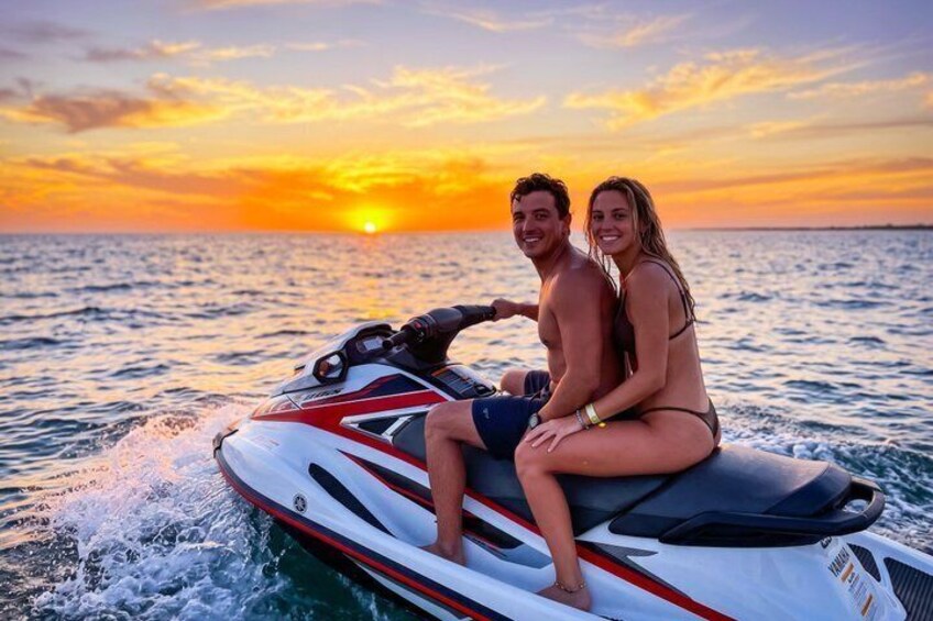 A couple on a jet ski at sunset. 3