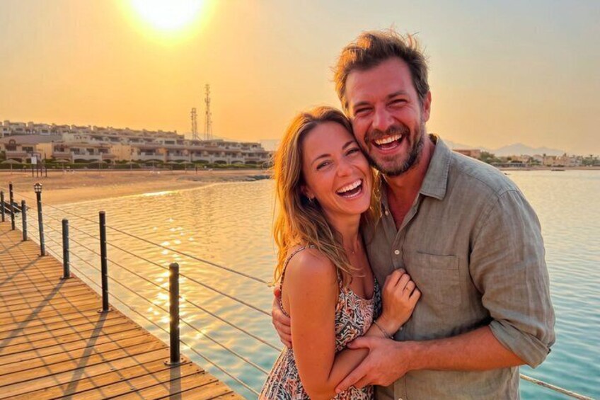 A couple embracing on a wooden pier with a sunset in the background. 2