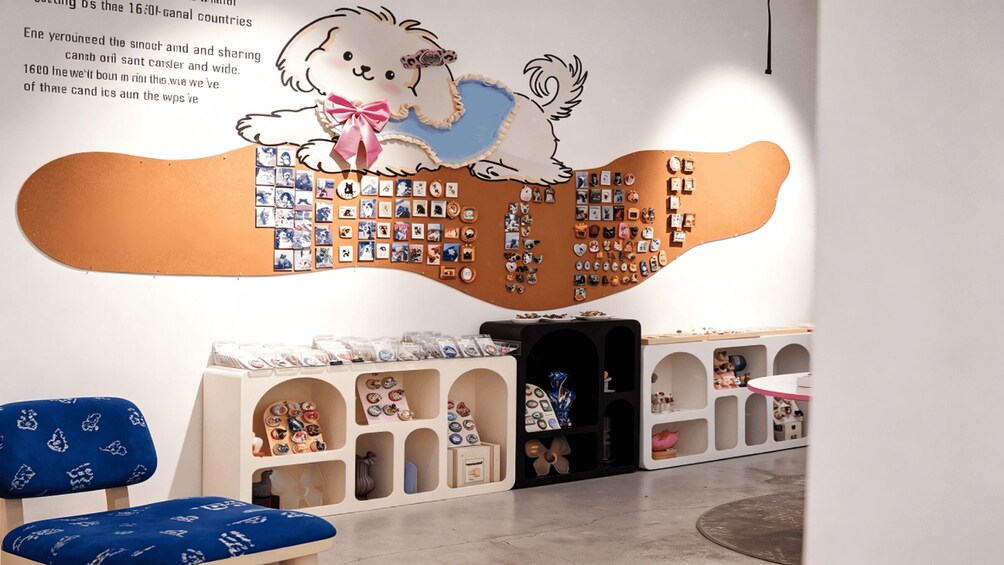 A wall with a large illustration of a dog and a display of various items. 2