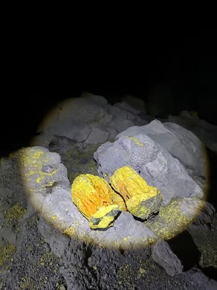 A cave with yellow lichen on rocks. 1