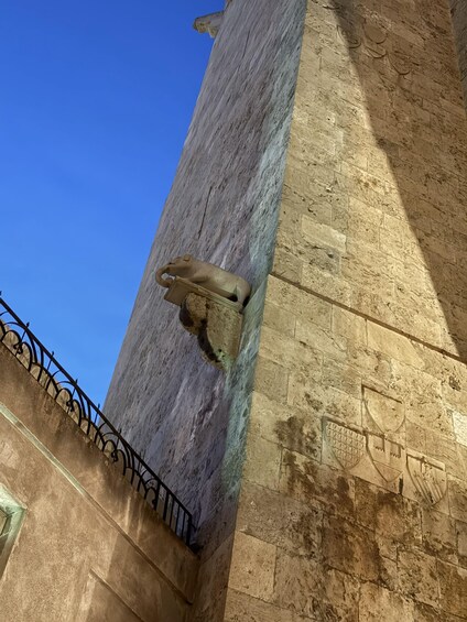 A stone wall with a metal fixture attached to it. 5