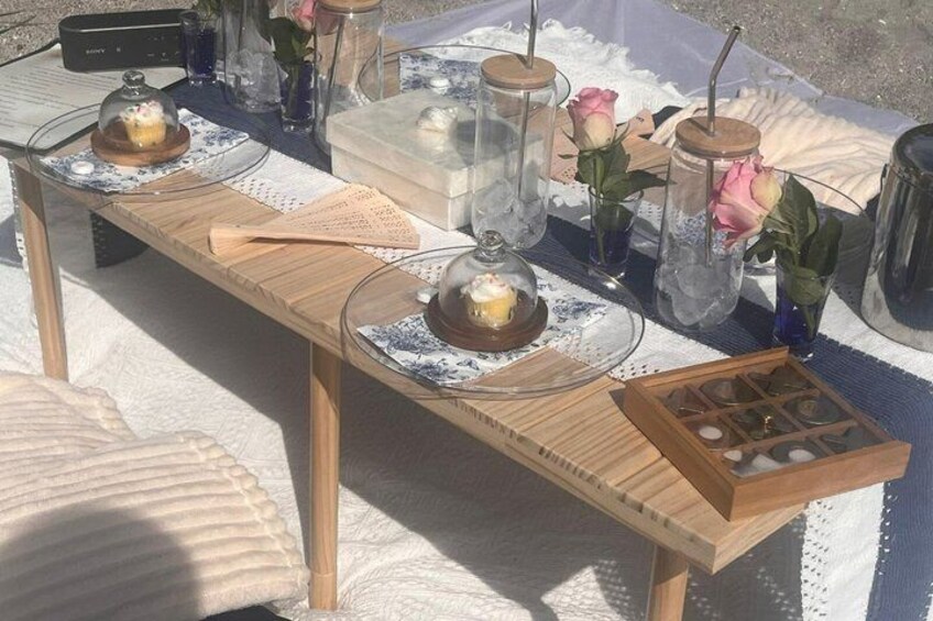 A wooden table with glass jars, candles, and a wooden box. 4