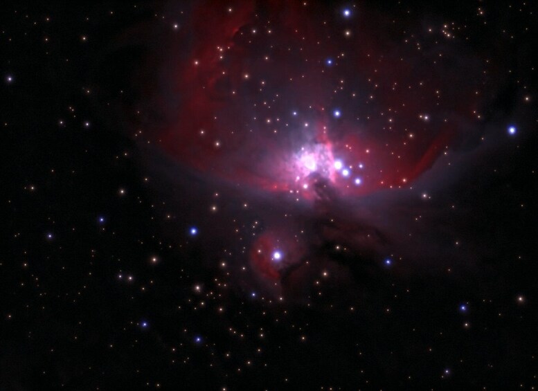 A nebula with bright stars and a central bright region. 4