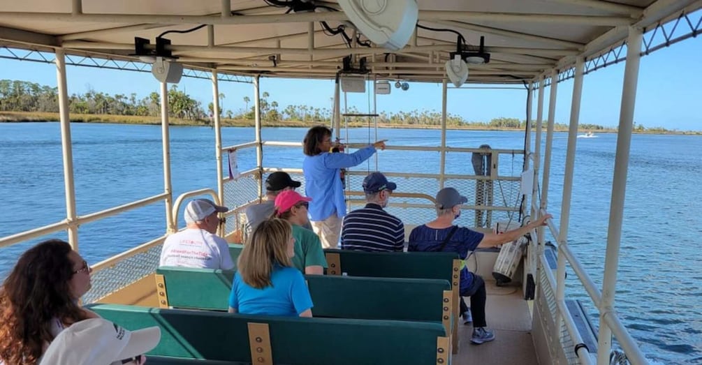 A boat tour with people looking out at the water. 2