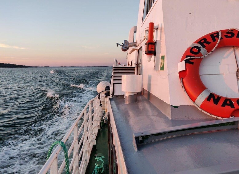 A lifebuoy on a ship's deck with the text 'NORGE' and 'NAT' visible. 3