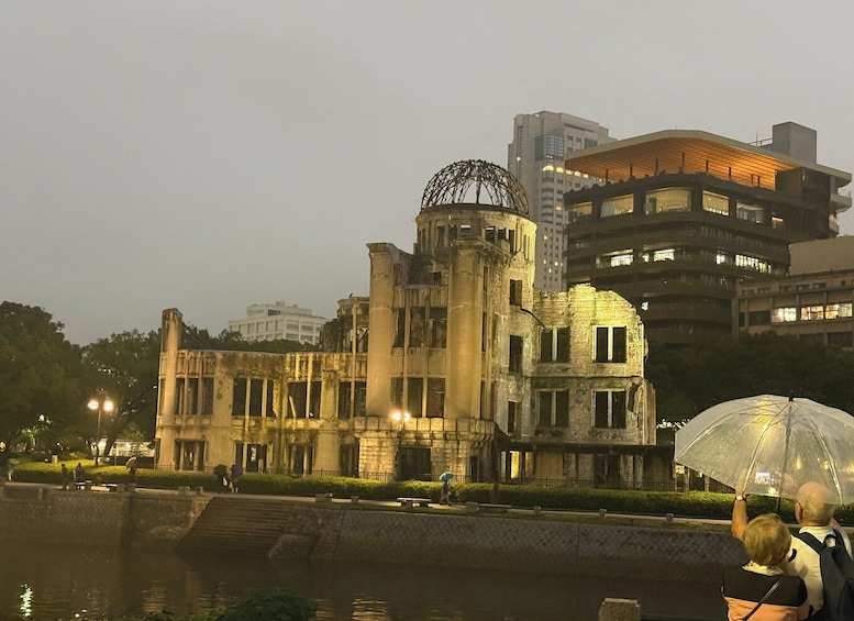 A historic building with classical architecture, a dome, and a modern building in the background. 5