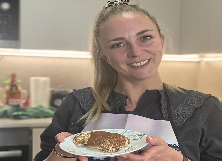 A person holding a plate with a food item. 3