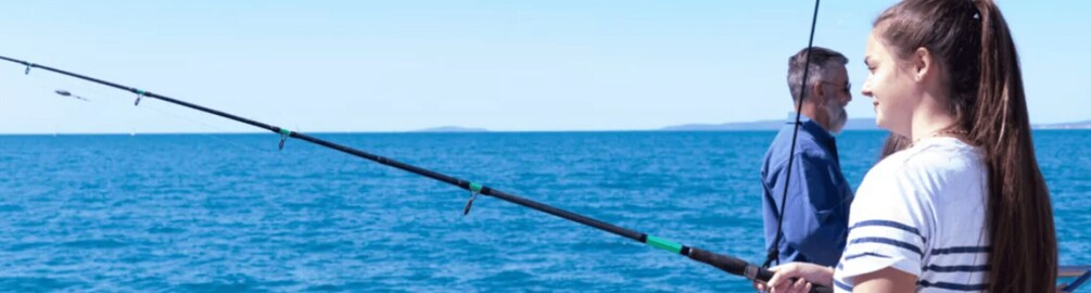 A person fishing by the sea with a fishing rod. 4