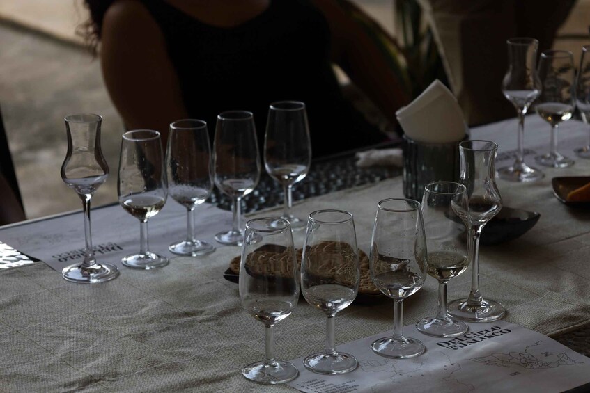 A table with empty wine glasses and a menu. 5