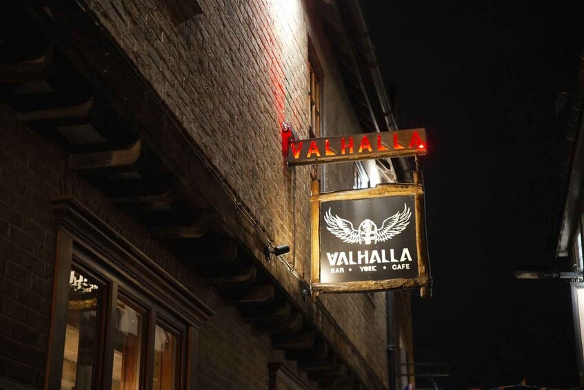 A building with a sign that reads 'VALHALLA BAR YORK CAFE' with a winged skull logo. 3