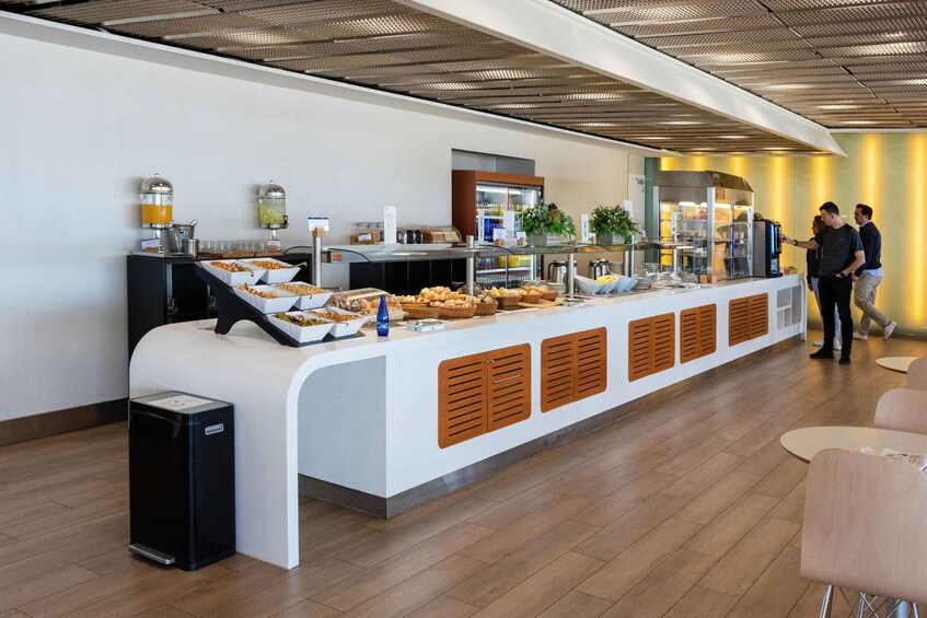 A buffet counter with various food items and a coffee machine. 2