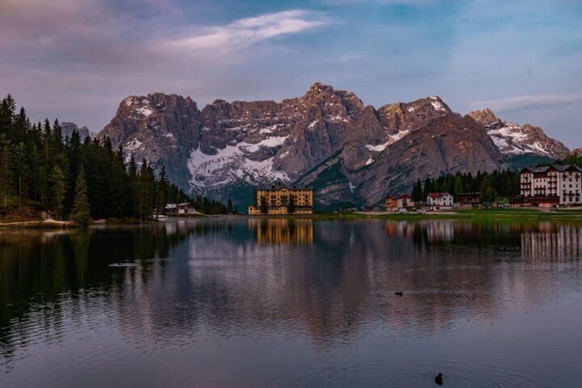 A mountain range, a lake, and buildings in the foreground. 3