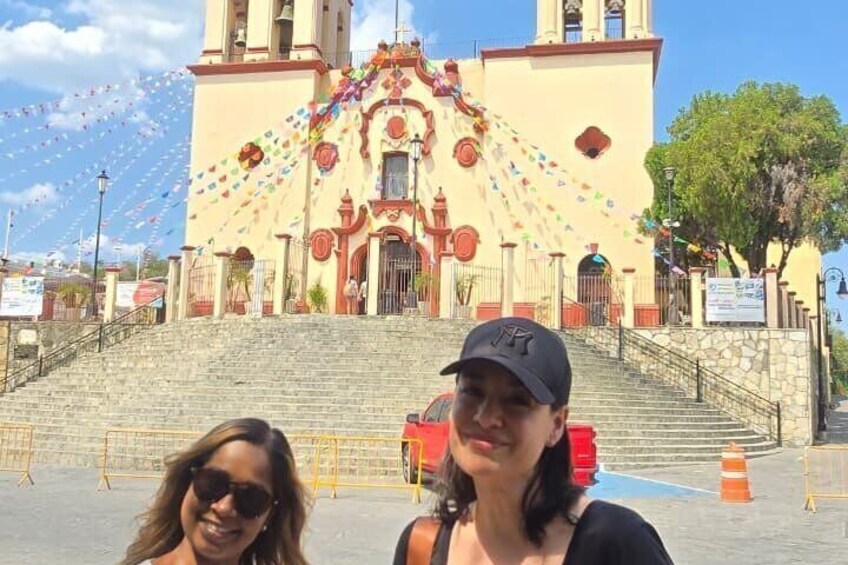 A church with colorful decorations, a staircase leading up to the entrance, and a clear blue sky. 5