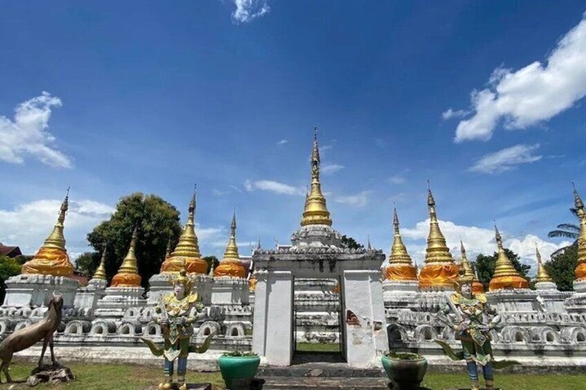 A temple complex with golden spires and a central entrance. 3