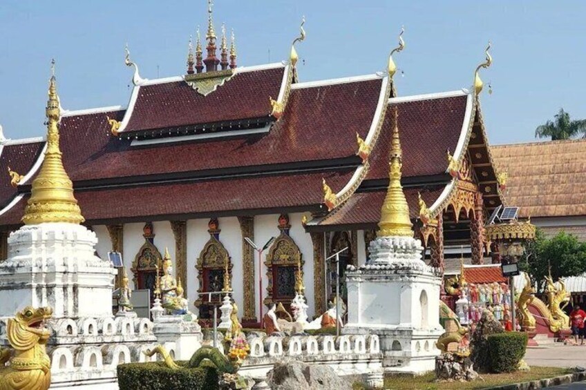A temple with ornate golden spires and white walls. 2
