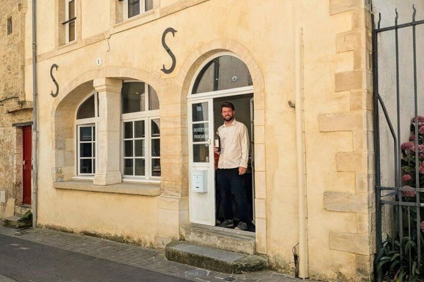 A building with arched windows and the letters 'S' and 'S' on the facade. 5