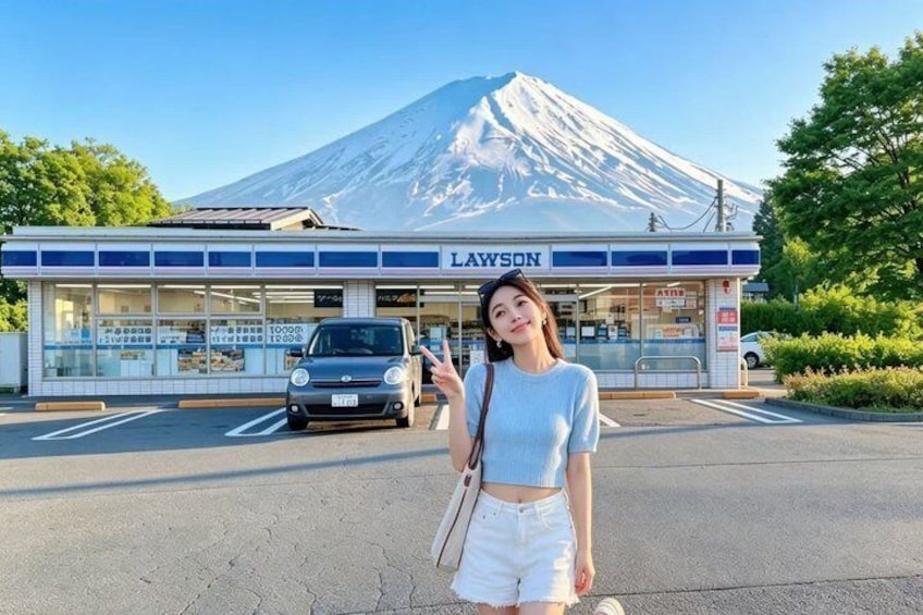 A person standing in front of a Lawson convenience store with a mountain in the background. 5