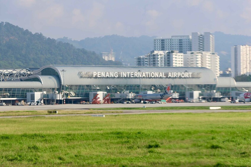 Penang International Airport with a modern terminal and surrounding buildings. 5