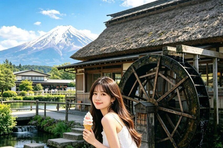 A traditional Japanese building with a water wheel, a mountain in the background, and a person holding an ice cream cone. 4