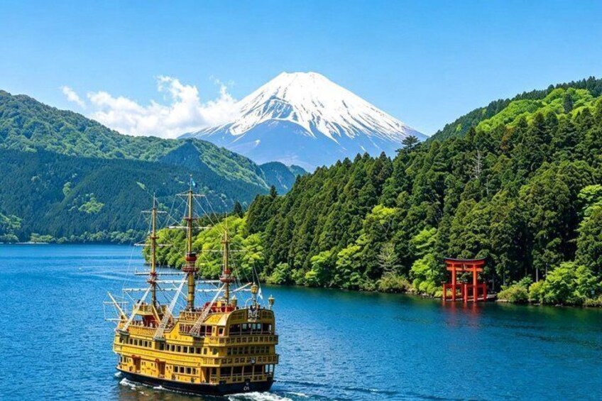 A traditional Japanese boat on a lake with a mountain in the background. 5