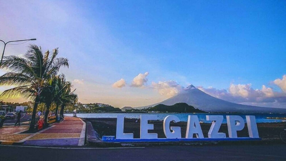 A coastal view with a large sign reading 'LEGAZPI' and a mountain in the background. 5