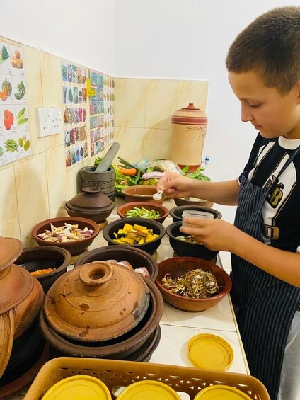 A person cooking with various ingredients and cookware. 3