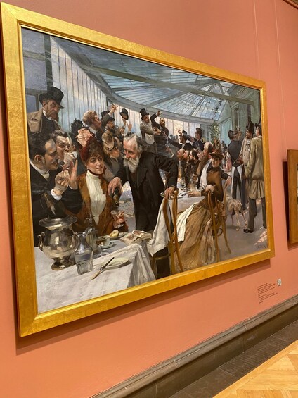 A large painting of a crowded room with people dining and socializing. 2