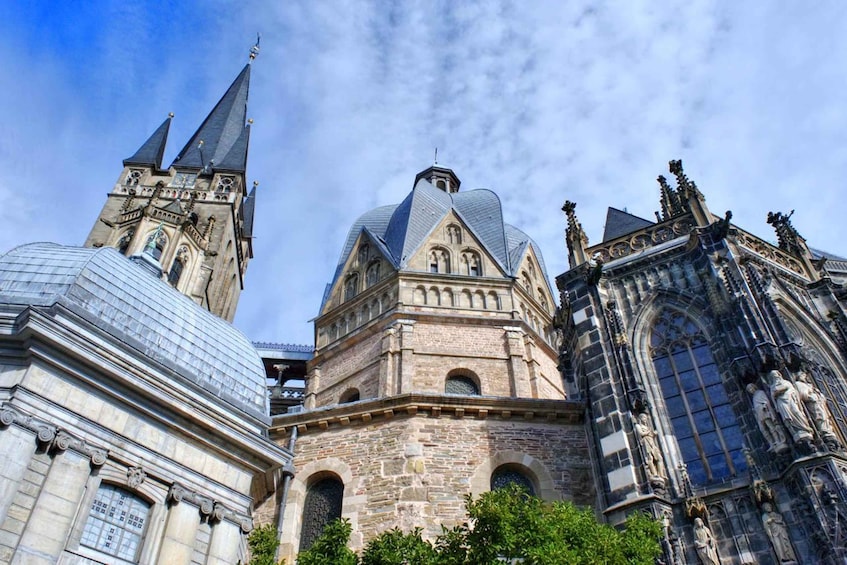 A historic building with a prominent tower, a large dome, and intricate stonework. 2