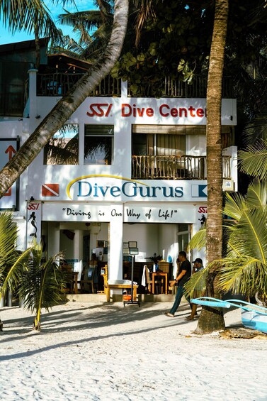 A building with a sign that reads 'Dive Center' and 'DiveGurus' with a slogan 'Diving is Our Way of Life!' 4