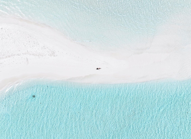 A sandy beach with clear turquoise water. 4
