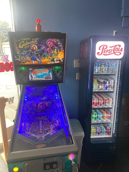 A pinball machine and a Pepsi-Cola vending machine. 1