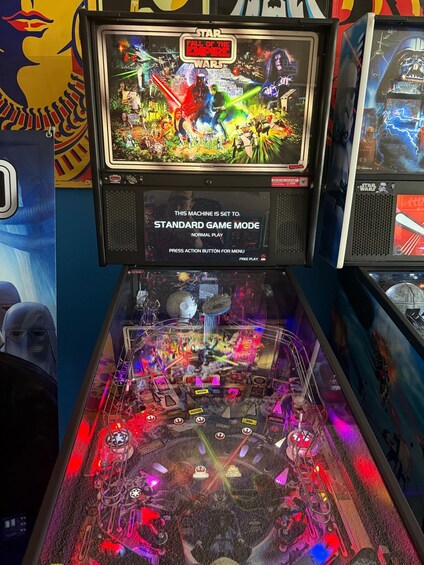 A pinball machine with a Star Wars theme, including a screen displaying 'Star Wars: The Fall of the Empire' and a play mode indicator. 5