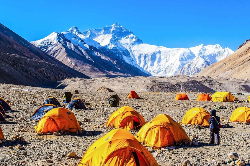 A mountainous landscape with tents and a person. 2