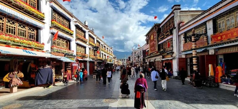 A bustling street with traditional buildings, shops, and people walking. 3
