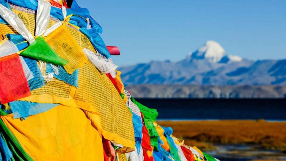 Colorful prayer flags, a mountain, and a clear sky. 5