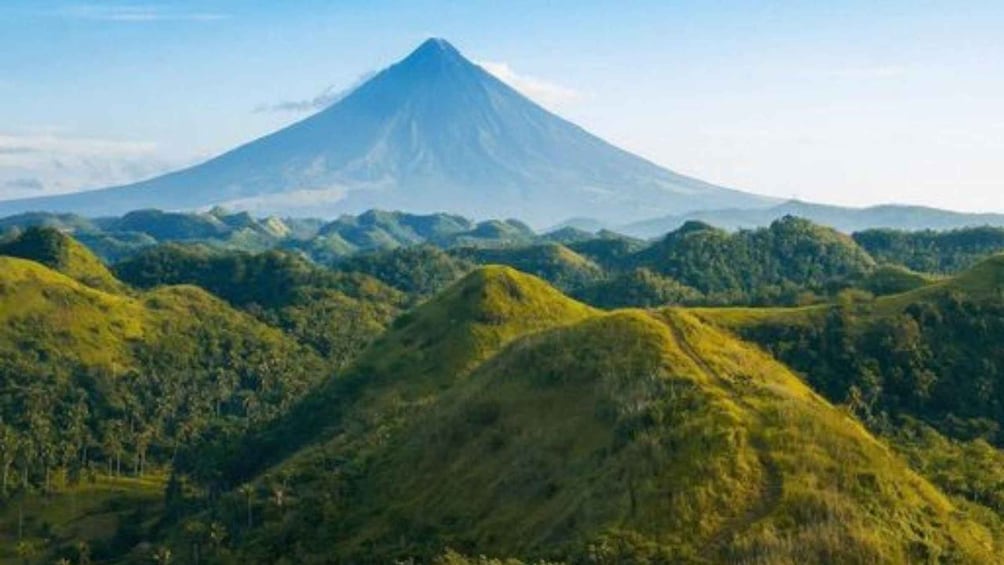 A mountain landscape with a prominent volcano in the background. 1