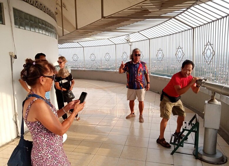 A group of people at a viewing platform with a telescope. 4