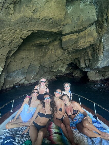 A group of people on a boat in a rocky cave. 3