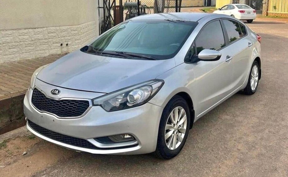 A silver sedan parked on a street. 4