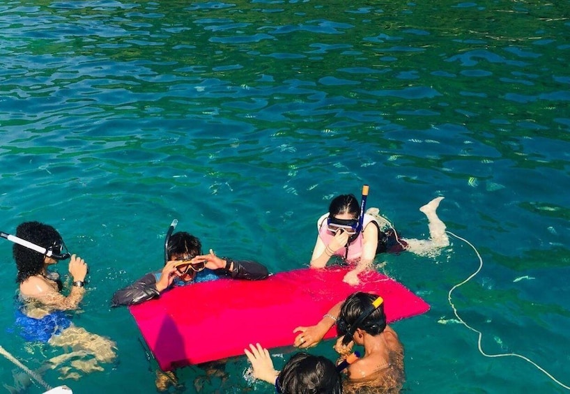 People snorkeling in clear blue water. 5