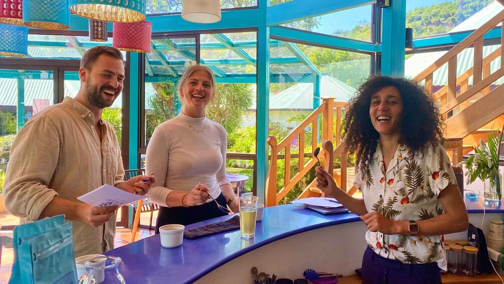 Three people at a counter with a view of greenery outside. 5